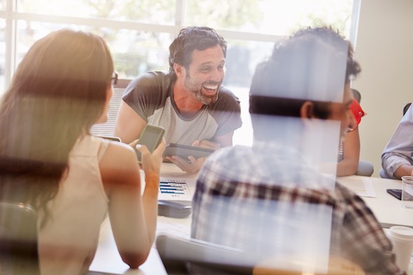 Excited people at a conference table